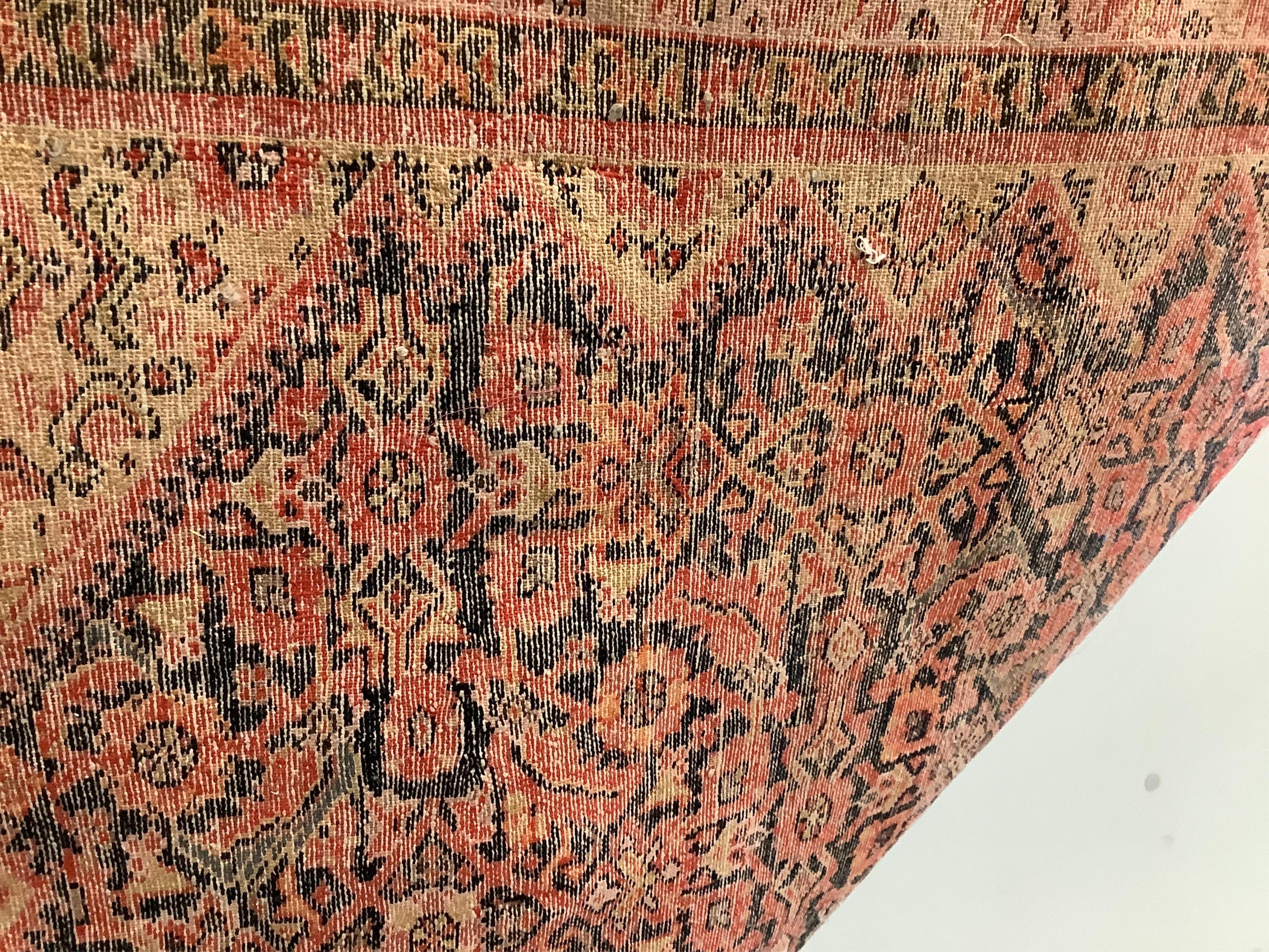 A Caucasian red ground rug, 192 x 129cm. Condition - faded and worn